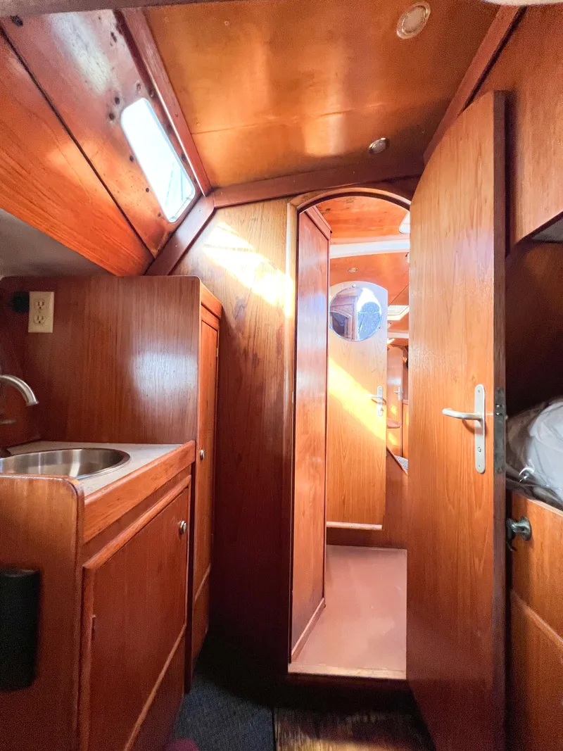Slide: The Image of Interior of a 1989 Jeanneau Voyage 11.20 yacht with wooden finish. - 26
