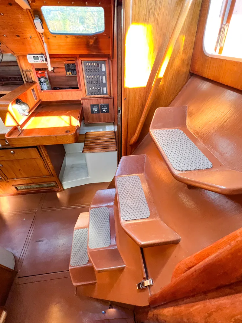 Slide: The Image of Interior of a 1989 Jeanneau Voyage 11.20 yacht with wooden finish and stairs. - 30