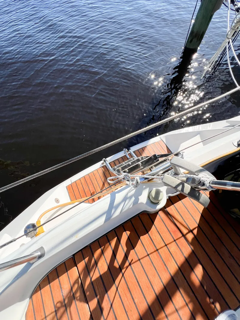 Slide: The Image of Deck of a 1989 Jeanneau Voyage 11.20 sailboat by the water. - 45