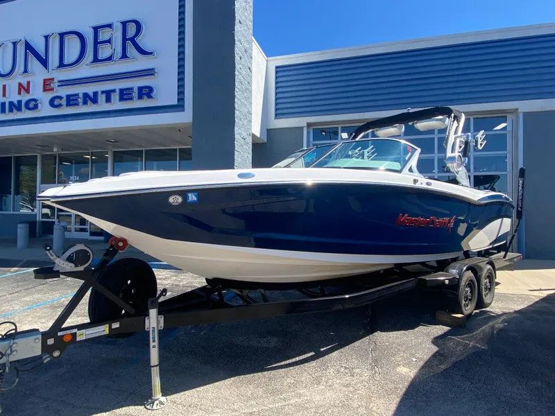 Slide: The Image of 2018 MasterCraft X26 boat on trailer outside marine center. - 0
