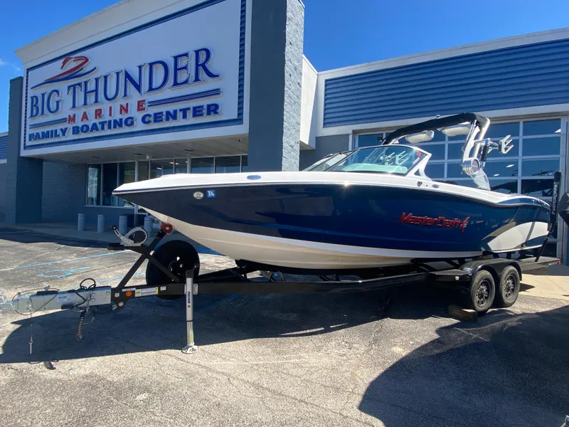 Slide: The Image of 2018 MasterCraft X26 boat on trailer at Big Thunder Marine dealership. - 1
