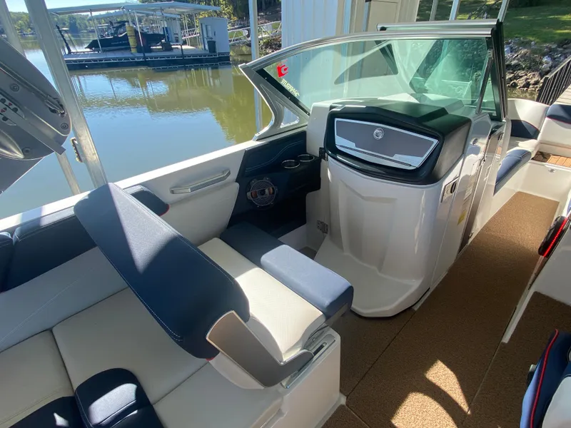 Slide: The Image of 2018 MasterCraft X26 boat interior with sleek seating and modern dashboard. - 23