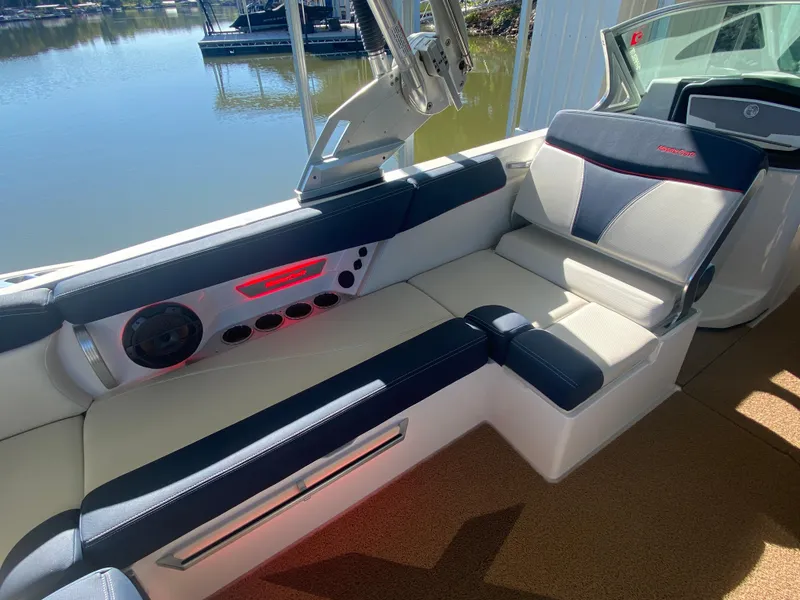 Slide: The Image of 2018 MasterCraft X26 boat interior with luxurious seating and modern audio system. - 24