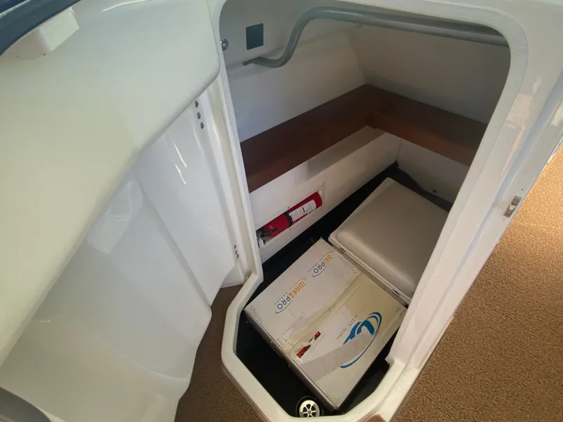 Slide: The Image of 2018 MasterCraft X26 interior storage area with seating and safety equipment. - 26