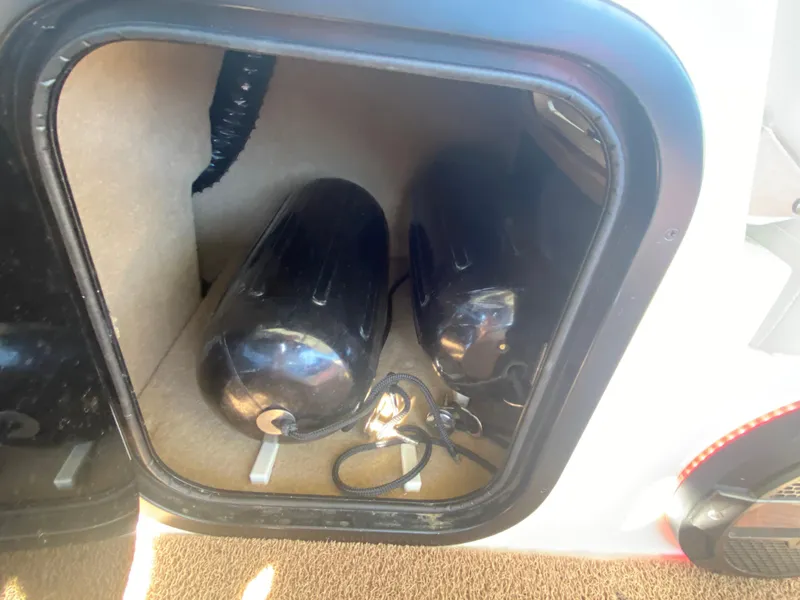 Slide: The Image of Storage compartment in 2018 MasterCraft X26 boat with black fenders. - 29