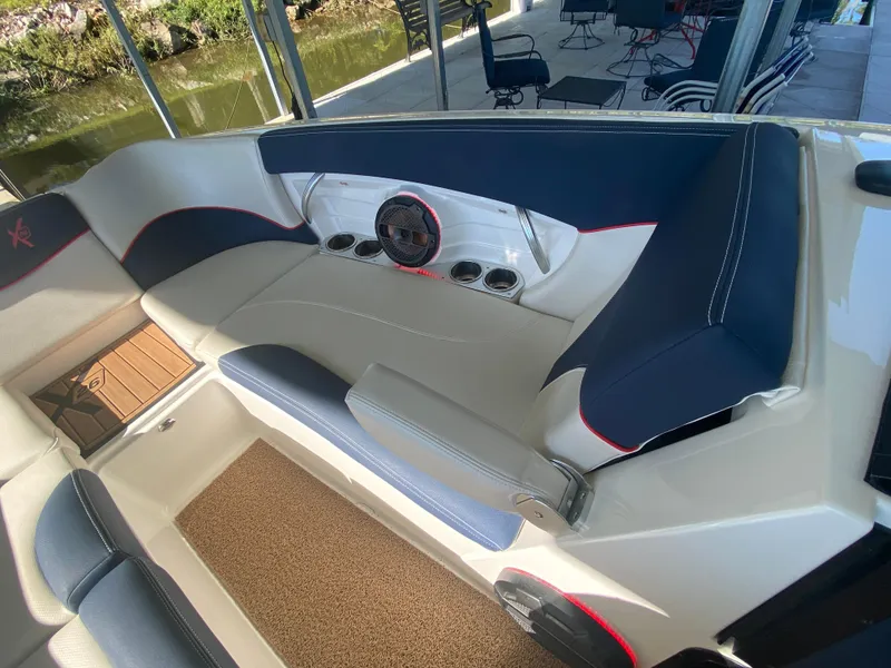 Slide: The Image of 2018 MasterCraft X26 boat interior with cushioned seating and cup holders. - 37