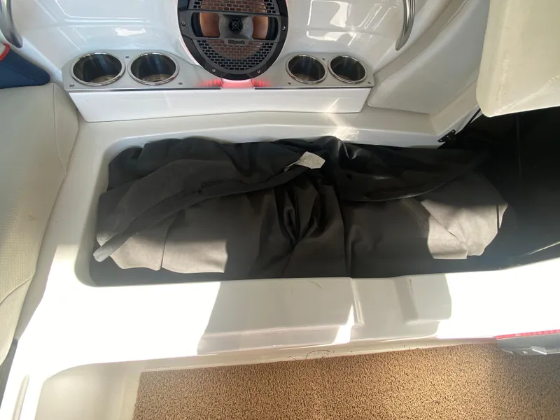 Slide: The Image of 2018 MasterCraft X26 boat storage compartment with black cover inside. - 39
