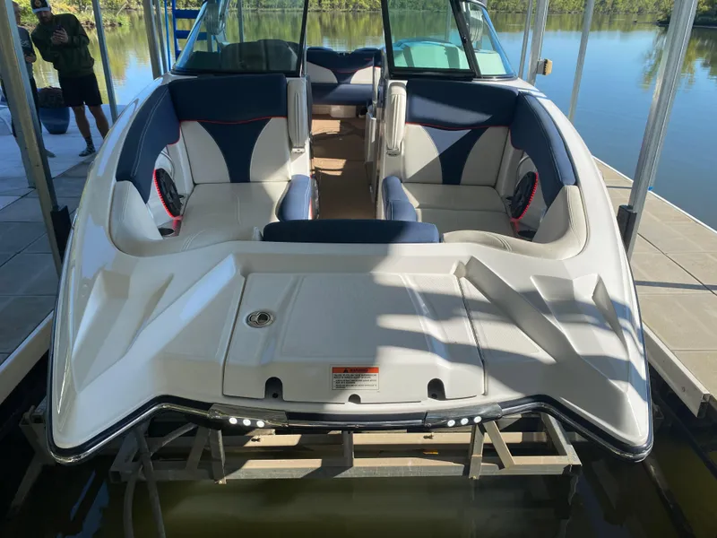 Slide: The Image of 2018 MasterCraft X26 boat with spacious seating, docked on a sunny day. - 40