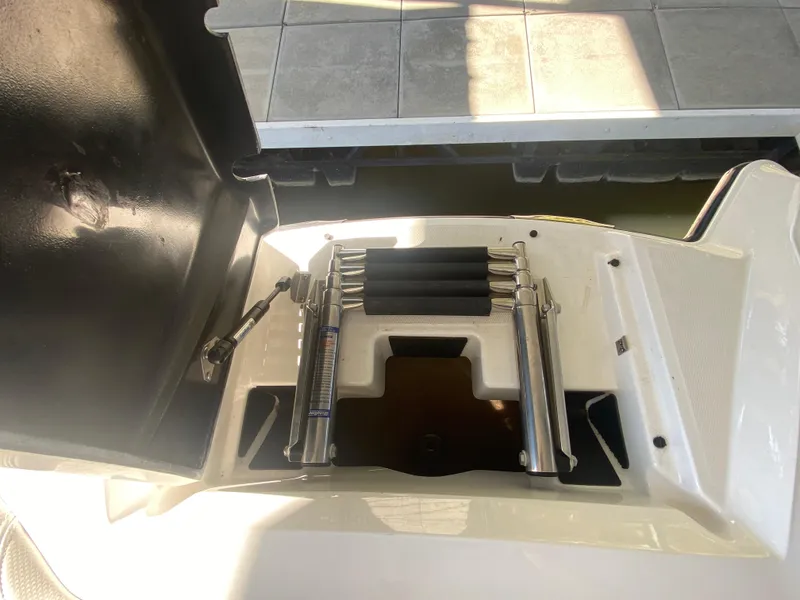 Slide: The Image of 2018 MasterCraft X26 boat ladder compartment with hydraulic supports. - 41