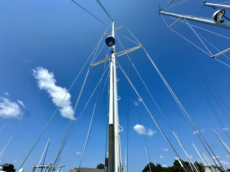 Slide: The Image of Mast of a 1999 Bowman 48 Aft Cockpit sailboat under blue sky. - 13