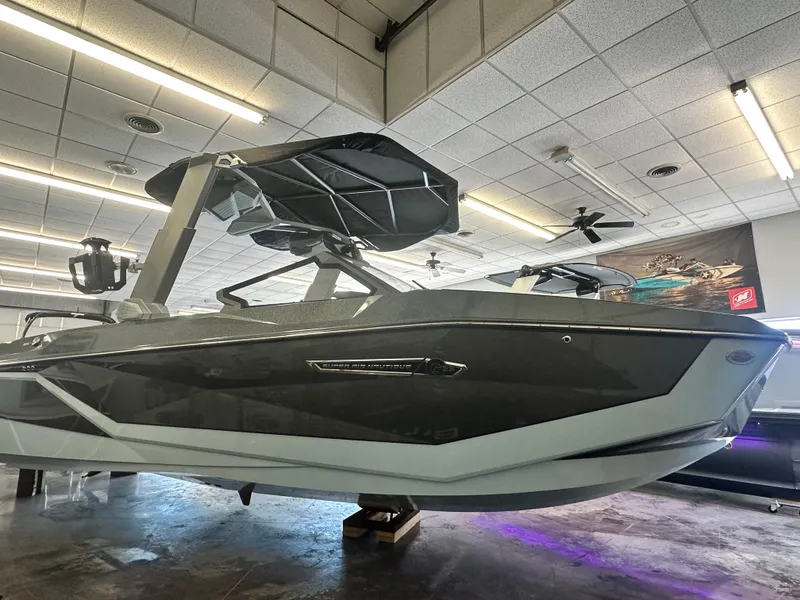 Slide: The Image of 2025 Nautique G25 boat in showroom, sleek design, modern features, under bright lighting. - 0