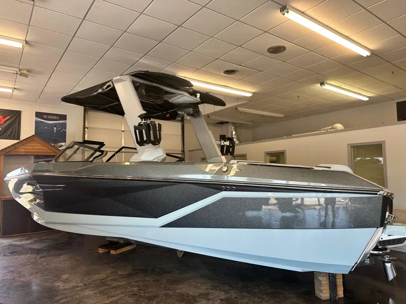 Slide: The Image of 2025 Nautique G25 boat in showroom, featuring sleek design and modern aesthetics. - 1