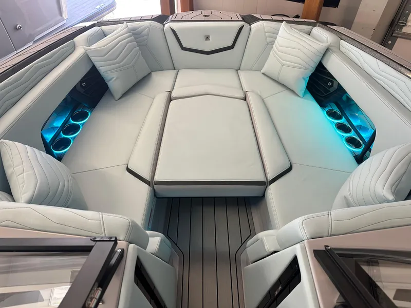 Slide: The Image of 2025 Nautique G25 boat interior with luxurious seating and ambient lighting. - 3