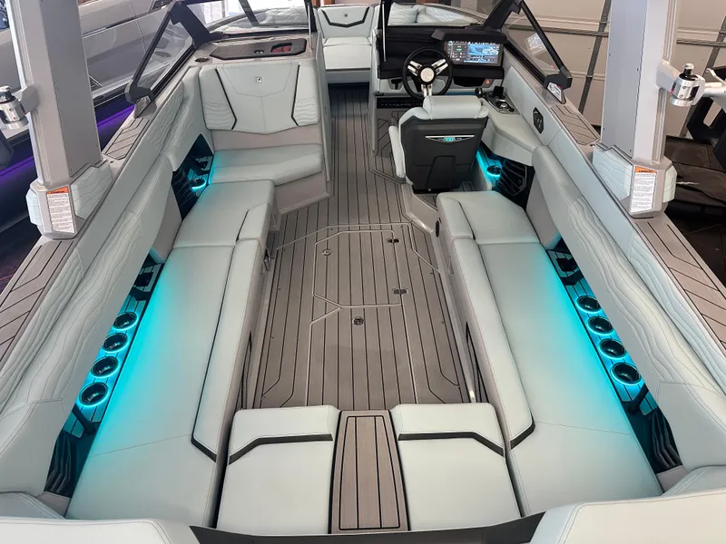 Slide: The Image of 2025 Nautique G25 boat interior with sleek seating and ambient blue lighting. - 5