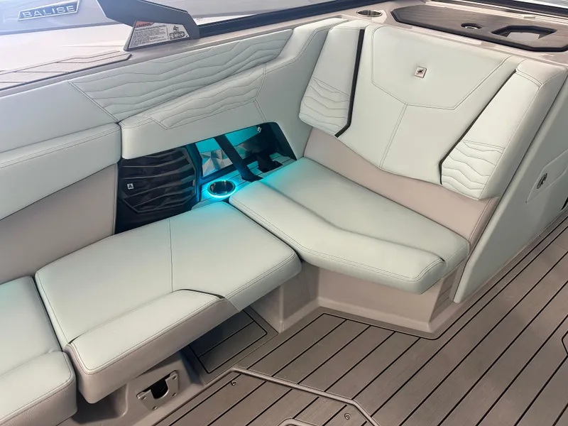 Slide: The Image of 2025 Nautique G25 boat interior with sleek seating and ambient lighting. - 6