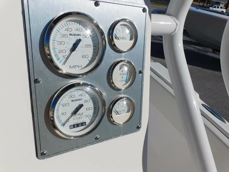 Slide: The Image of Close-up of 2023 Clearwater 2200 WI Center Console gauges, featuring speedometer and fuel indicators. - 17