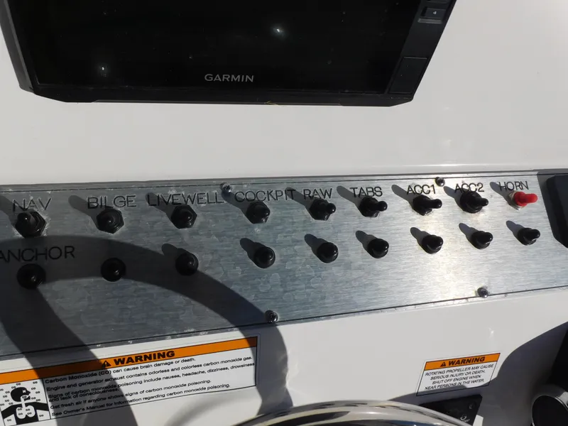 Slide: The Image of Control panel of 2023 Clearwater 2200 WI Center Console boat with labeled switches. - 19