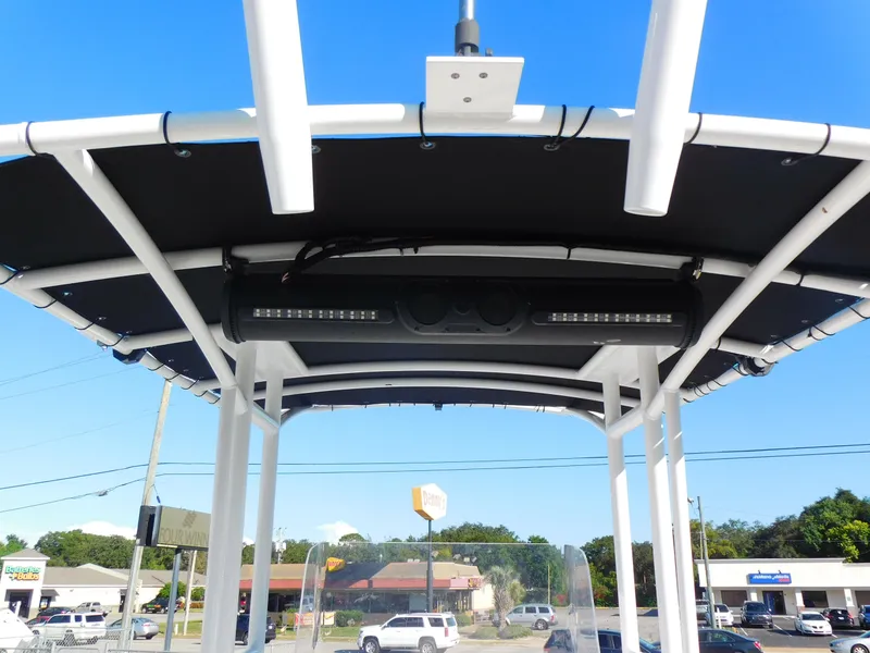 Slide: The Image of 2023 Clearwater 2200 WI Center Console boat canopy with LED lights, outdoor setting. - 25
