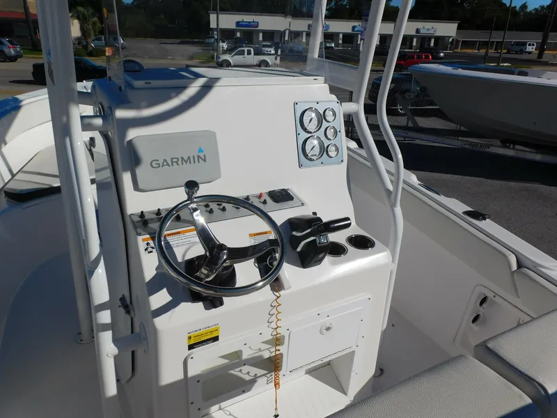 Slide: The Image of 2023 Clearwater 2200 WI Center Console boat with Garmin navigation system and steering controls. - 7