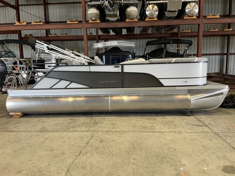 The Image of 2024 Crest 220 SLSC Classic DLX pontoon boat in a storage facility. - 1