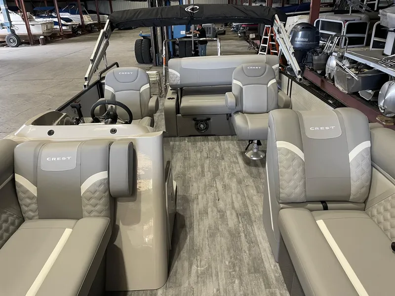 Slide: The Image of 2024 Crest 220 SLSC Classic DLX pontoon boat interior with luxurious seating and modern design. - 10