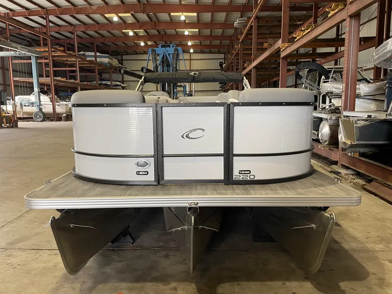 Slide: The Image of 2024 Crest 220 SLSC Classic DLX pontoon boat in a warehouse setting. - 2