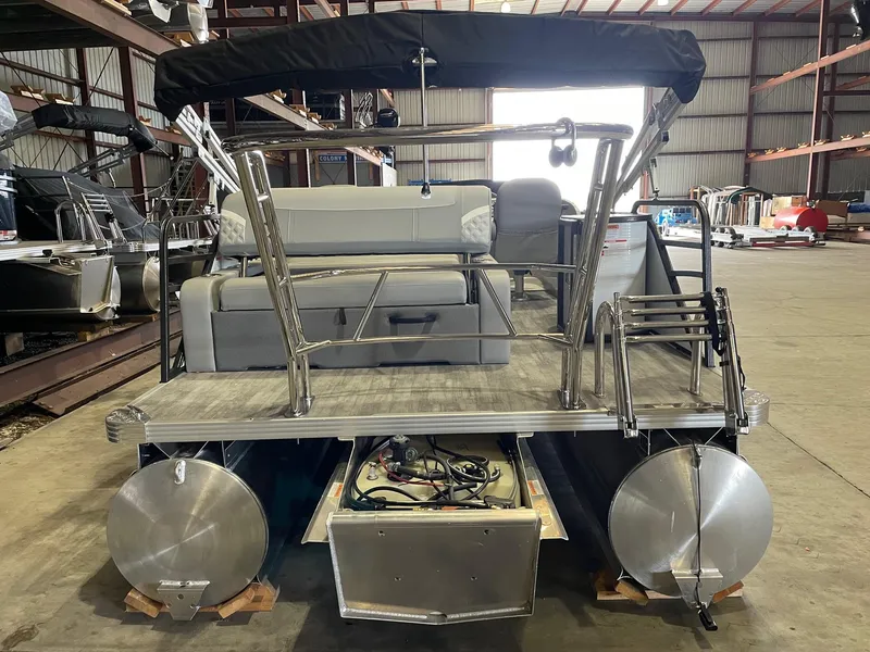Slide: The Image of 2024 Crest 220 SLSC Classic DLX pontoon boat in warehouse, rear view. - 3