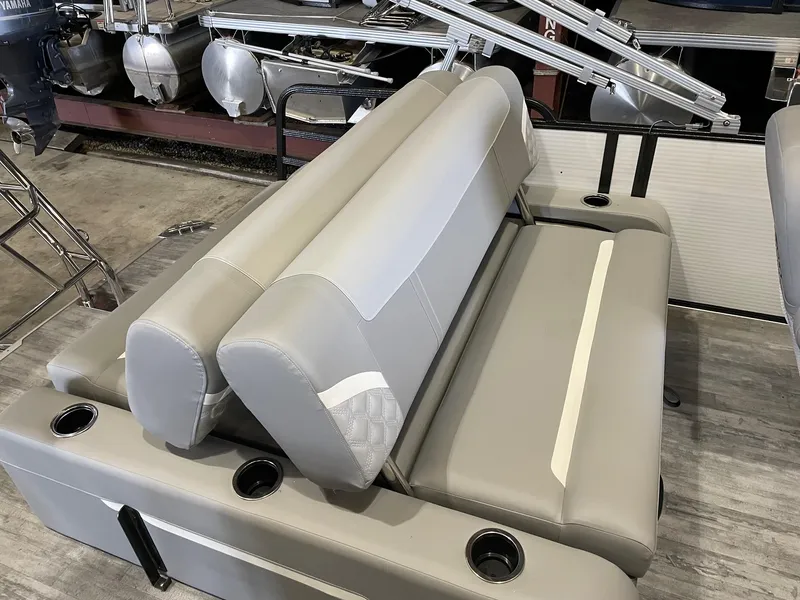 Slide: The Image of 2024 Crest 220 SLSC Classic DLX boat seating, featuring gray upholstery and integrated cup holders. - 5