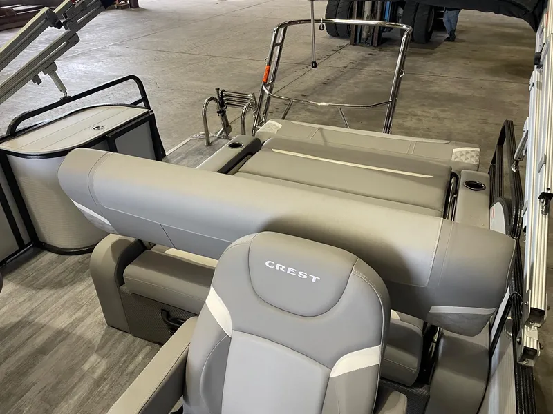 Slide: The Image of 2024 Crest 220 SLSC Classic DLX boat interior with gray seating and modern design. - 7