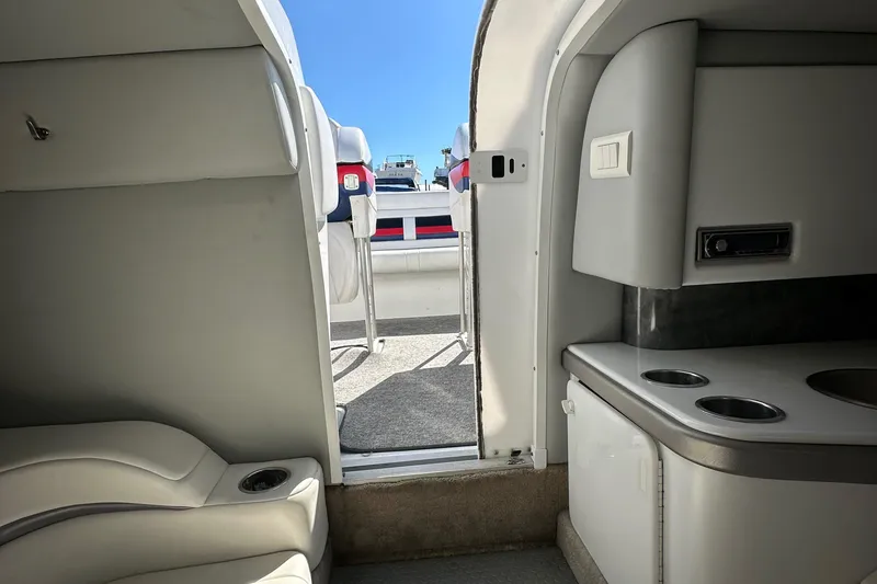 Slide: The Image of Interior view of a 2004 Formula 292 FASTech boat, featuring seating and a compact kitchenette. - 10