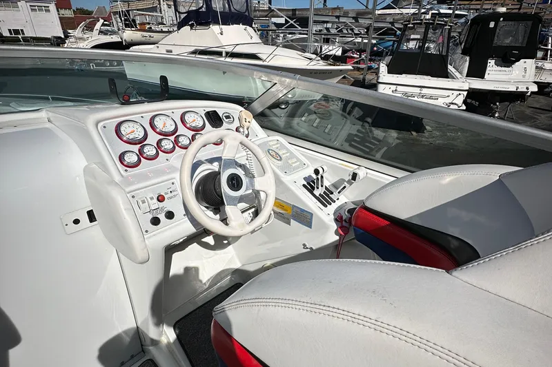 Slide: The Image of 2004 Formula 292 FASTech boat cockpit with steering wheel and gauges. - 11