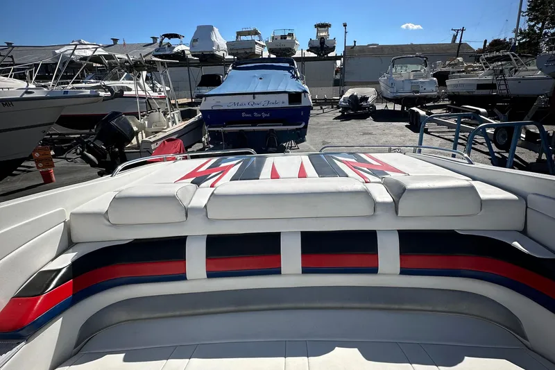 Slide: The Image of 2004 Formula 292 FASTech boat with colorful seating, docked among other boats. - 7