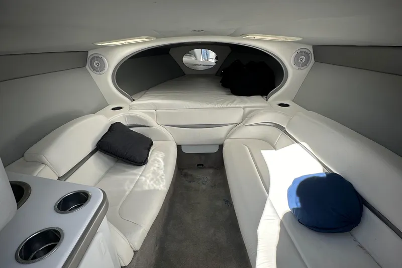Slide: The Image of 2004 Formula 292 FASTech boat interior with white seating and cozy cabin space. - 8