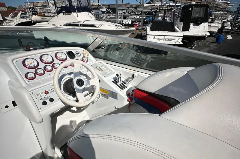 Slide: The Image of 2004 Formula 292 FASTech boat cockpit with white steering wheel and gauges. - 9