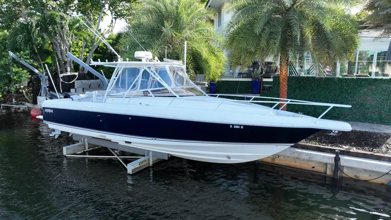 The Image of 2005 Intrepid 348 WA boat docked near palm trees. - 0