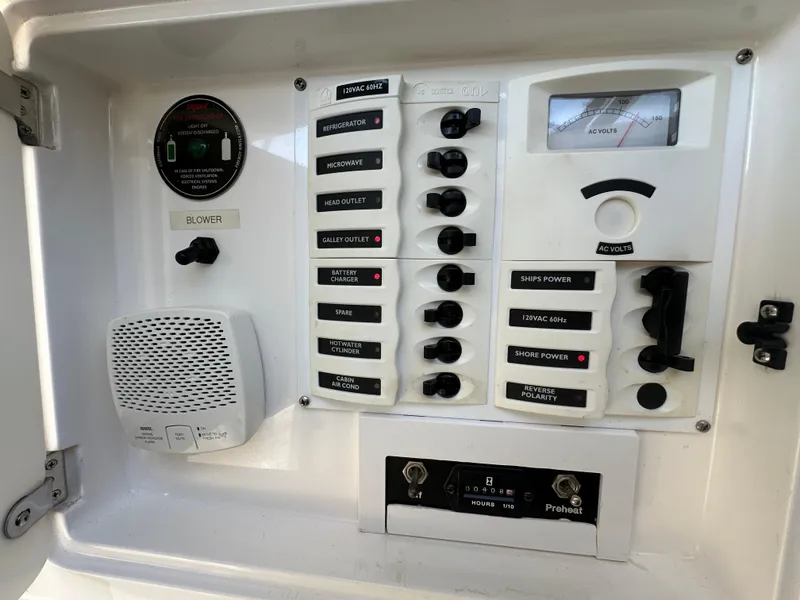 Slide: The Image of Control panel of a 2005 Intrepid 348 WA boat with various switches and gauges. - 13