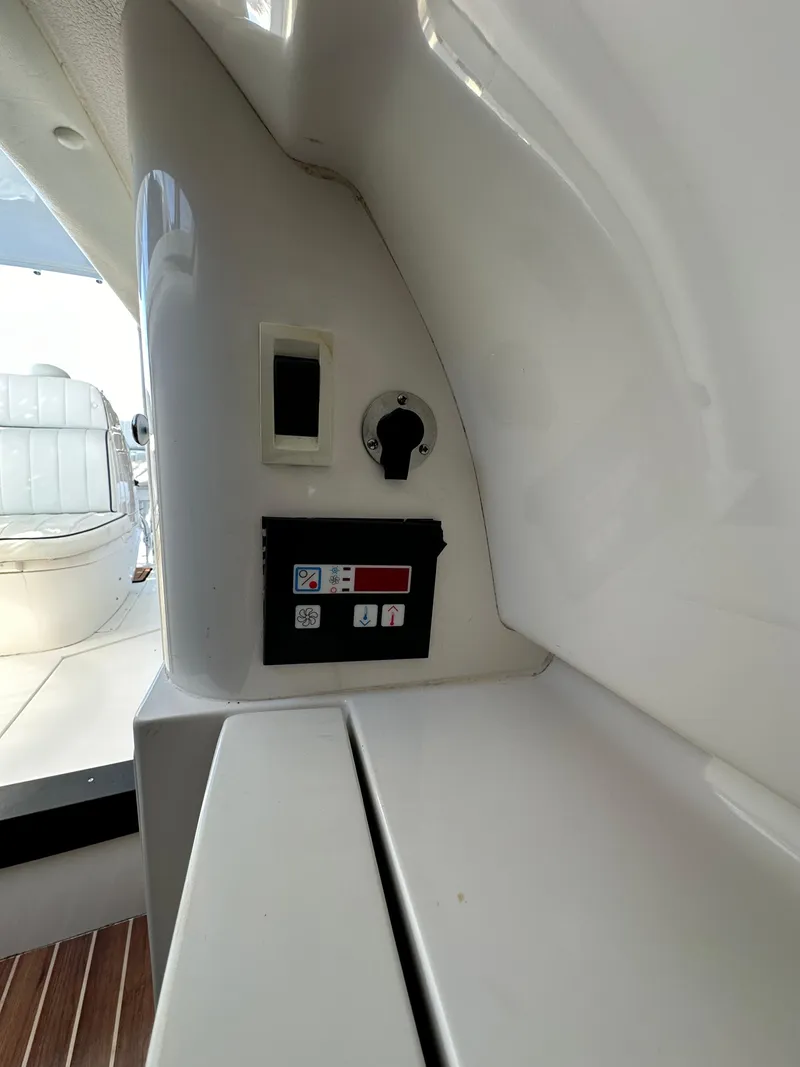 Slide: The Image of Control panel inside 2005 Intrepid 348 WA boat, featuring switches and gauges. - 14