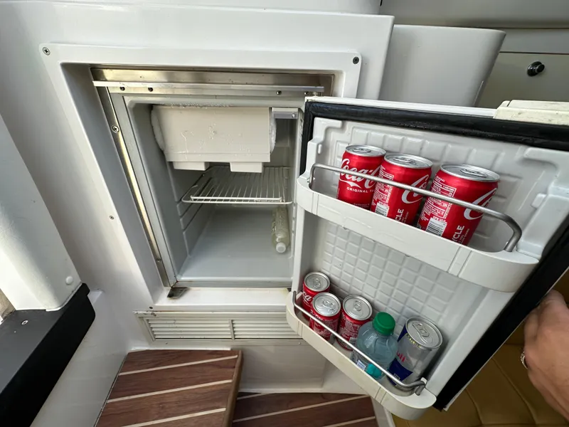 Slide: The Image of Mini fridge on 2005 Intrepid 348 WA boat, stocked with drinks. - 15