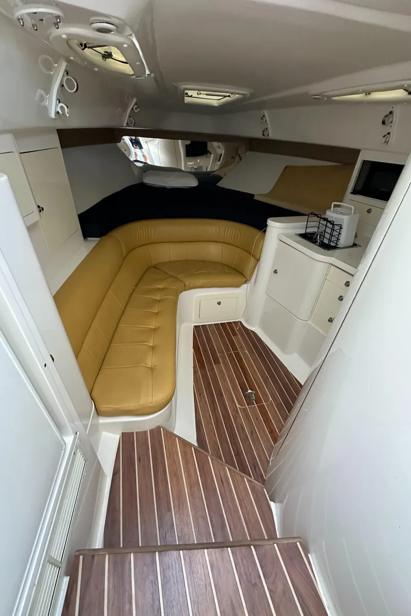 Slide: The Image of Interior of 2005 Intrepid 348 WA boat with tan seating and wood flooring. - 18