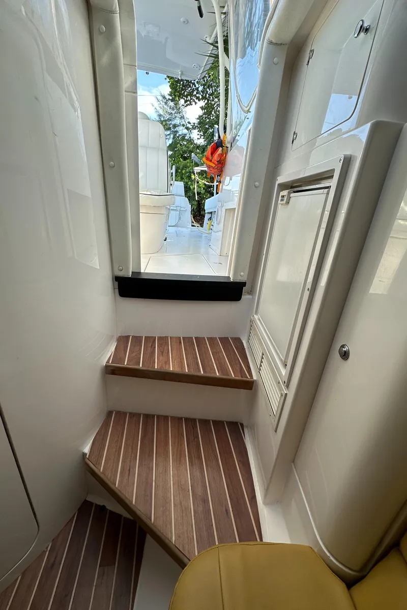 Slide: The Image of Interior view of 2005 Intrepid 348 WA boat with wooden steps and sleek design. - 20