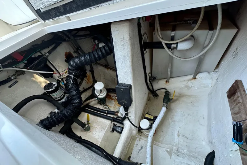 Slide: The Image of Engine compartment of a 2005 Intrepid 348 WA boat, showing hoses and mechanical components. - 21