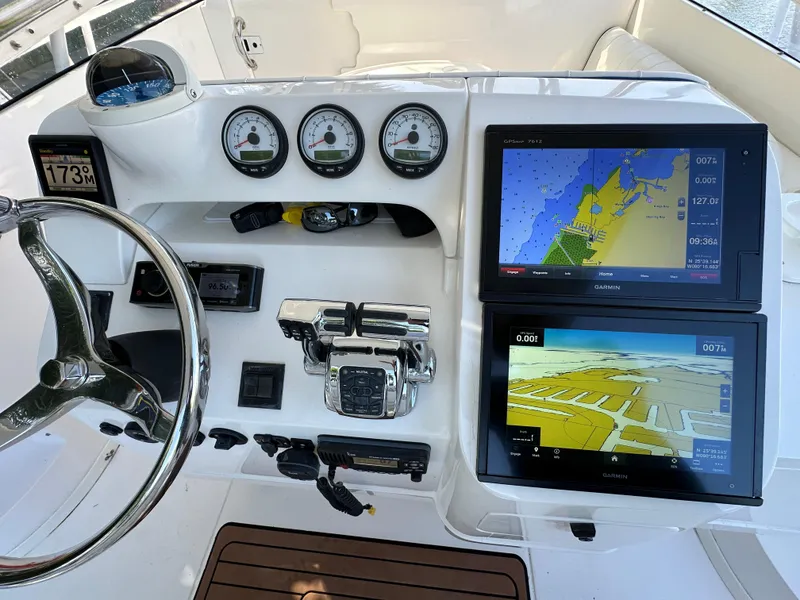 Slide: The Image of 2005 Intrepid 348 WA boat dashboard with navigation screens and gauges. - 4