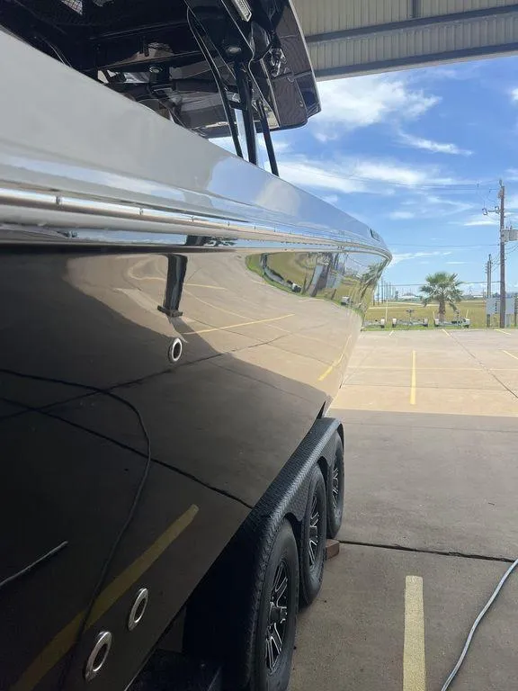 Slide: The Image of 2018 Fountain 38CC LS boat in a parking area, side view. - 11