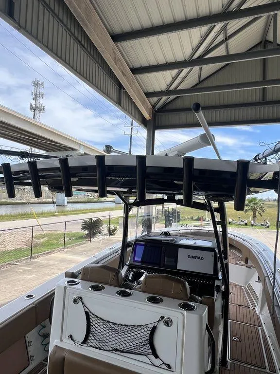Slide: The Image of 2018 Fountain 38CC LS boat under shelter, featuring modern navigation equipment. - 12