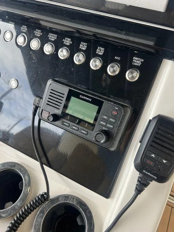 Slide: The Image of Garmin radio system on 2018 Fountain 38CC LS boat dashboard with control switches. - 17