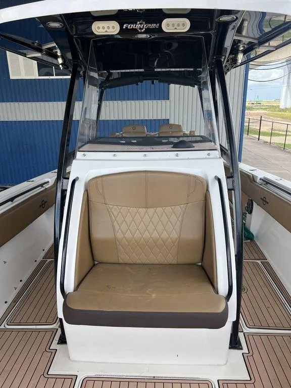 Slide: The Image of 2018 Fountain 38CC LS boat interior with tan seating and sleek design. - 26