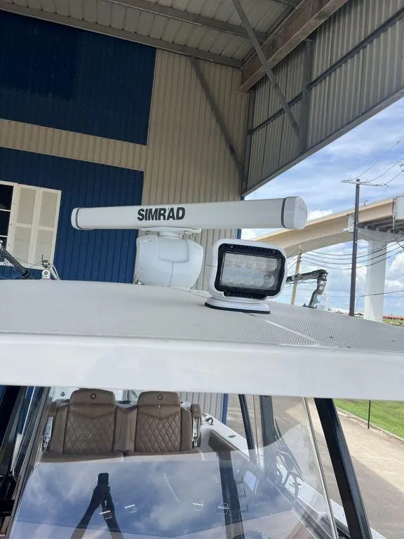 Slide: The Image of 2018 Fountain 38CC LS boat with Simrad radar and spotlight on roof. - 27