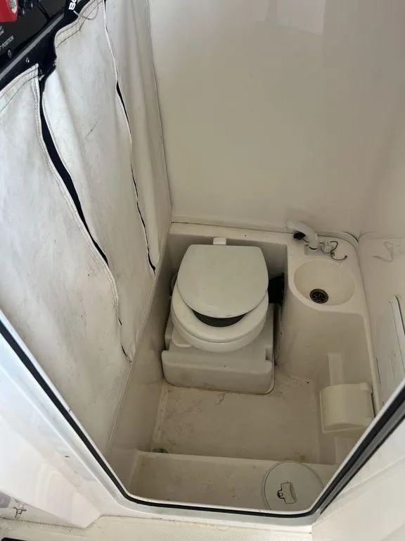 Slide: The Image of 2018 Fountain 38CC LS boat bathroom with compact toilet and sink. - 29