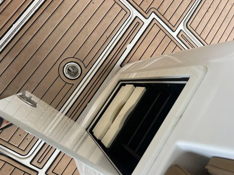 Slide: The Image of Open storage compartment on 2018 Fountain 38CC LS boat with teak flooring. - 32