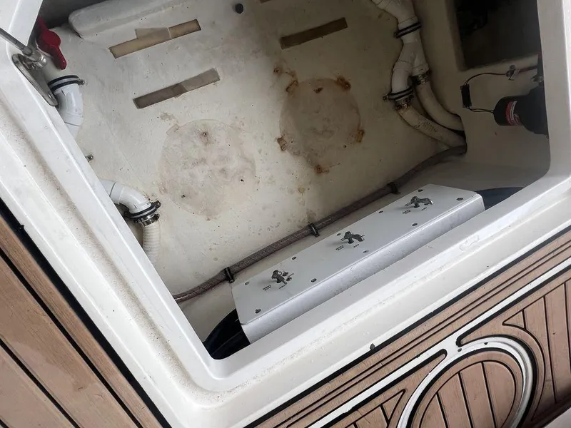 Slide: The Image of Open storage compartment of 2018 Fountain 38CC LS boat with visible pipes and fittings. - 33